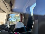 a seat in the back of a truck with a bag on it