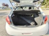 a white car with its trunk open in a parking lot