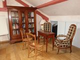 a room with a desk, chair, and bookcase in it