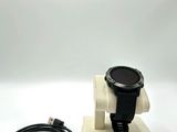 a close up of a watch on a stand with a charger