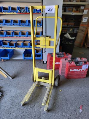 a yellow forklift with a sign on it in a garage