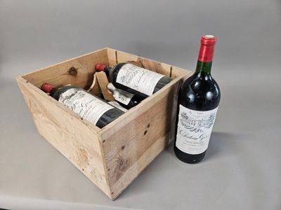 two bottles of wine in a wooden box next to a bottle of wine
