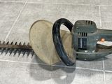 an image of a hedger on the ground with a cord