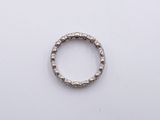 a close up of a silver ring on a white surface