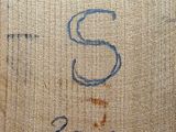 a close up of a piece of wood with writing on it
