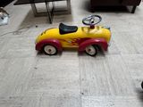 a toy car that is sitting on the floor in the living room