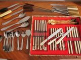 many different types of silverware on the table