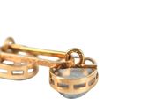 pair of yellow gold cufflinks with a blue topaz stone in the middle