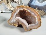 a slice of agate sitting on a table next to other rocks