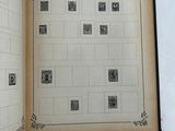 someone is holding a book open to a page with stamps on it