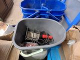 two buckets of tools sitting on the floor next to a trash can