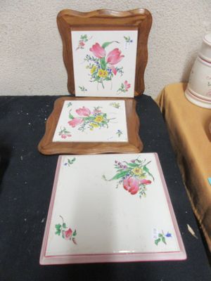 a picture of a table with a mirror and a picture of flowers on it