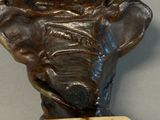 a bronze bust of a man with a clock on top of it