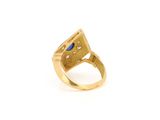 a close up of a gold ring with a blue stone
