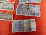 several bills of different currency are laid out on a table