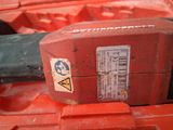 a close up of a red machine with a sticker on it ' s side
