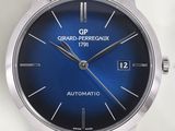 a close up of a wrist watch with a blue dial
