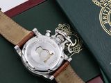 a watch sitting on top of a book with a passport in the background
