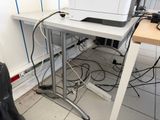 a printer sitting on top of a white desk