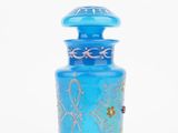 an image of a blue glass bottle with gold designs