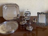 a table with silver items on it and a mirror on the table