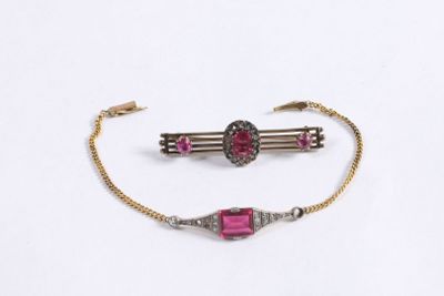 two pieces of jewelry are shown on a white surface