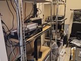 a room with a lot of wires and electronics on the shelves