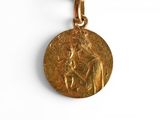 an image of a gold medal with a woman holding a child