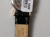 a close up of a watch on a white surface