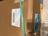 a cardboard box that has been wrapped up and is sitting on a pallet