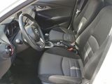 the interior of a white car with black seats and a steering wheel