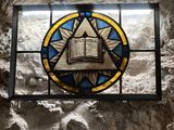 a stained glass window with a book on it