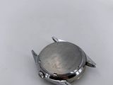 a close up of a watch sitting on top of a white table