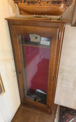 a grandfather clock sitting on top of a wooden cabinet