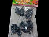 a bag of black glittered lollipops on a black background