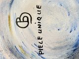 a white plate with a blue and yellow design on it