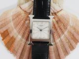 a watch that is sitting on top of a shell