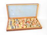 a wooden box filled with assorted items on a white surface