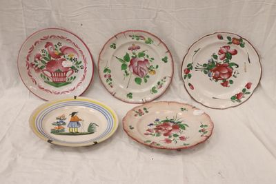 four plates with different designs on them sitting on a white surface