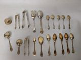 a lot of silver spoons and spoon spoons on the table