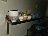 many bowls and bowls on a shelf in the kitchen