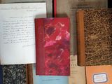 many old books sitting on a table next to each other