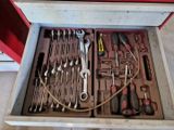 a drawer full of tools that are sitting on the floor