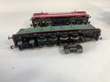 two toy trains sitting on a table next to each other