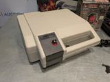 an old nintendo game console sitting on a table
