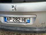 a silver car with a horse on the back of it