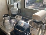 a kitchen counter with a mixer, blender, and other items on it