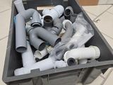 a lot of pipes in a box on the floor