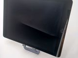 a tablet computer sitting on a stand on a white surface