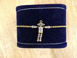 a small blue velvet box with a gold cross on it